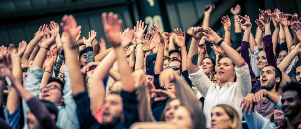 istock Crowd cheering for their team with arms raised 1130790196