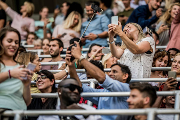 istock People taking selfies in a stadium crowd 1130790197