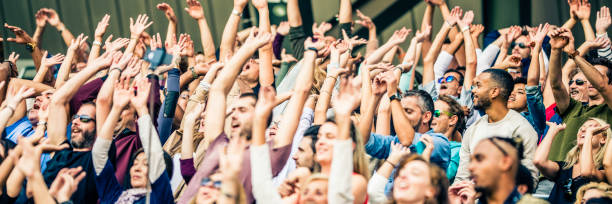 istock Crowd cheering for their team with arms raised 1130790198