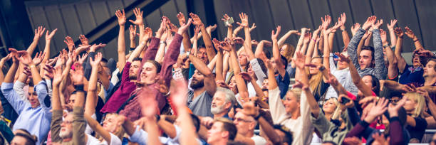 istock Crowd cheering for their team with arms raised 1130790199