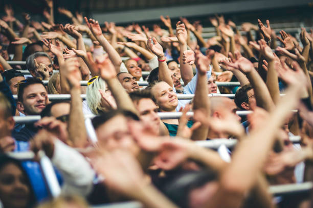 istock Crowd cheering for their team with arms raised 1130790207