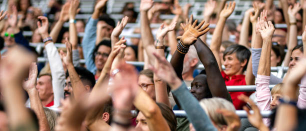 istock Crowd cheering for their team with arms raised 1130790214