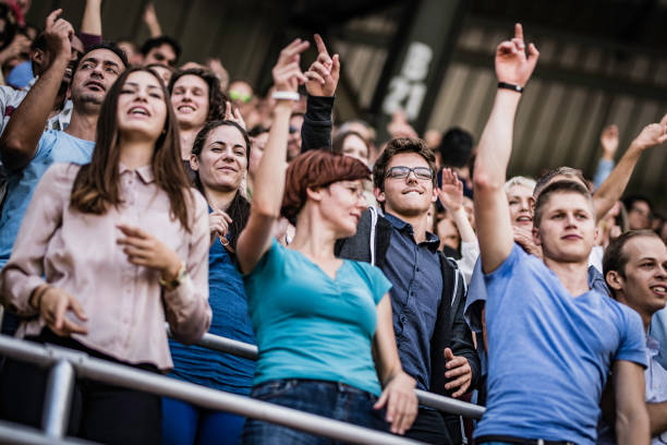 istock People on a stadium with raised hands during a concert 1130790215