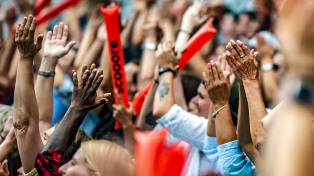 istock Crowd cheering for their team with arms raised 1130790222
