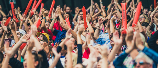 istock Crowd cheering for their team with arms raised 1130790233