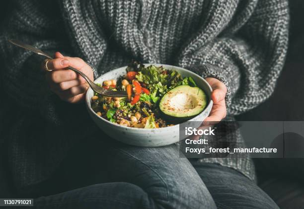 Woman In Sweater Eating Fresh Salad Avocado Beans And Vegetables Stock Photo - Download Image Now