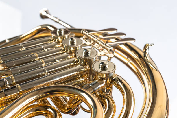 istock French horn on a white table. Beautiful polished musical instrument. Light background. 1130791207