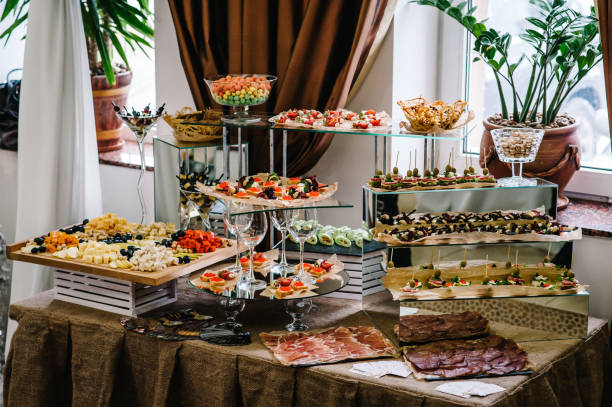 istock Light snacks in a plate on a buffet table. Assorted mini canapes, delicacies and snacks, restaurant food at event. Seafood. A gala reception. Decorated delicious table for a party goodies. 1130791247