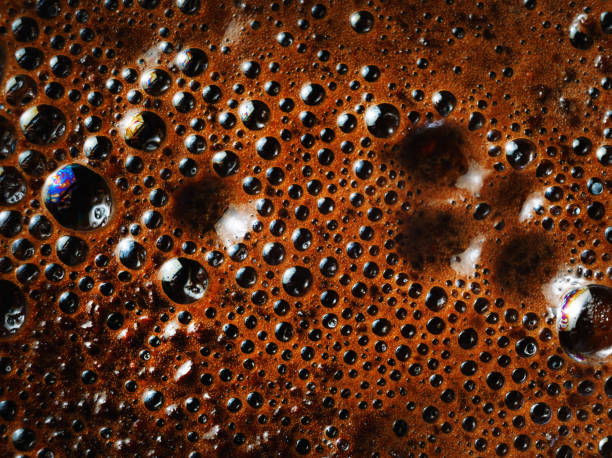 Coffee foam close-up Macro shot of coffee foam. Coffee crema close-up. foam material photos stock pictures, royalty-free photos & images