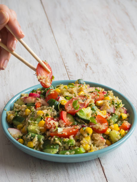 istock Chopsticks eat salad with quinoa. Close up. 1130792937