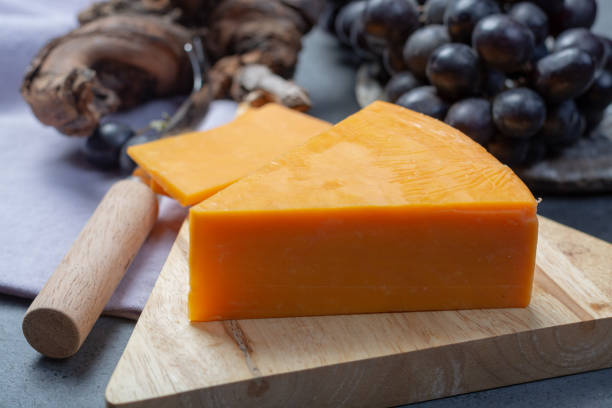 istock Piece of hard orange Cheddar cheese close up 1130794204