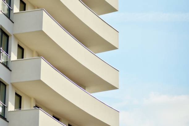 istock Modern white building with balcony on a blue sky 1130796408