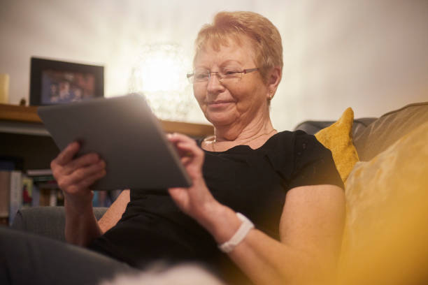 istock Happy smiling senior woman using digital tablet 1130796627