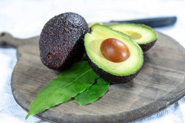 istock Two ripe raw hass avocados close up 1130798263