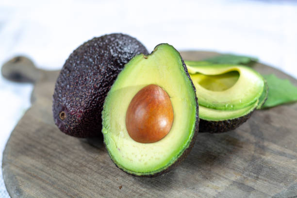 istock Two ripe raw hass avocados close up 1130798265