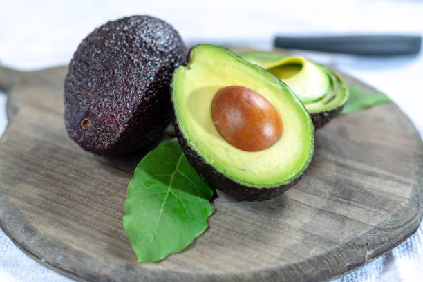 istock Two ripe raw hass avocados close up 1130798275
