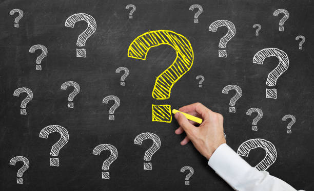 istock teacher drawing a yelow question mark on blackboard 1130798657