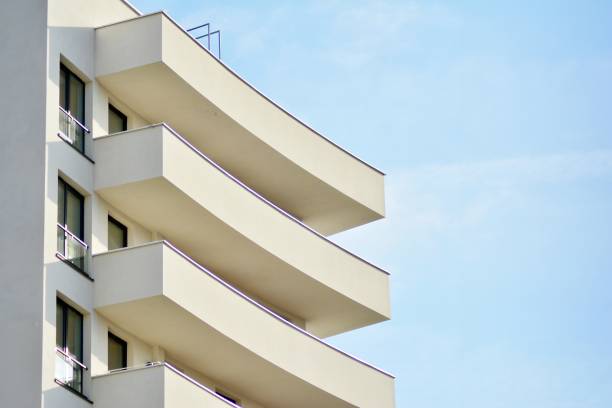 istock Modern white building with balcony on a blue sky 1130800595