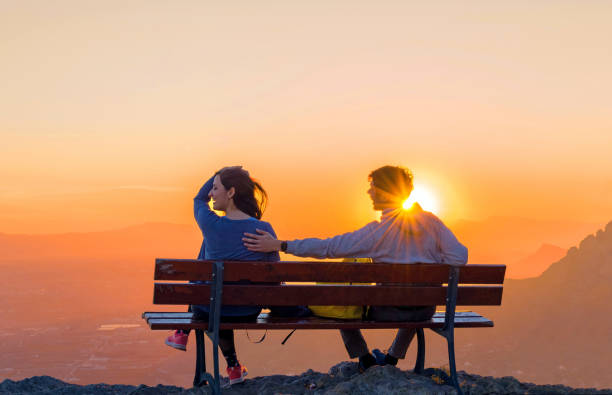 istock Romantic scene of couple watching sunrise. 1130800603