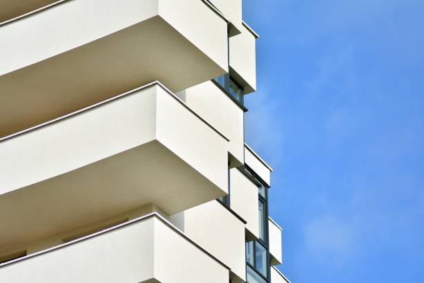 istock Modern white building with balcony on a blue sky 1130801819