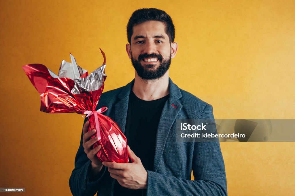 Happy Easter. Happy man holding chocolate easter egg 30-39 Years Stock Photo