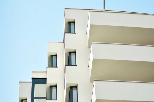 istock Modern white building with balcony on a blue sky 1130803093