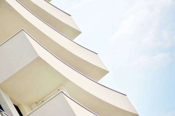 istock Modern white building with balcony on a blue sky 1130803118