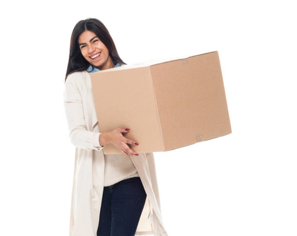 istock Attractive young latino female is holding a box 1130809371