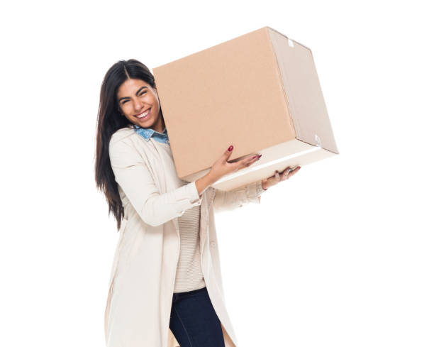 istock Attractive young latino female is holding a box 1130809375