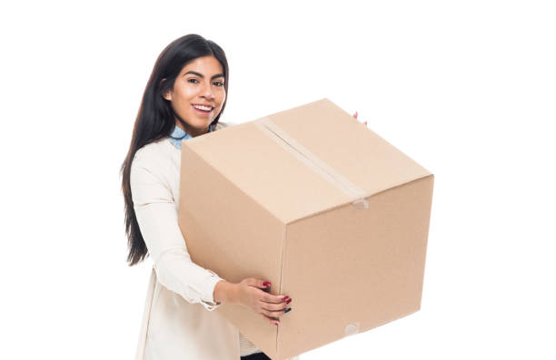 istock Attractive young latino female is holding a box 1130809376
