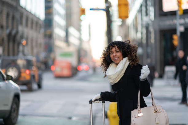 istock Woman on sidewalk waits for her ride 1130810254