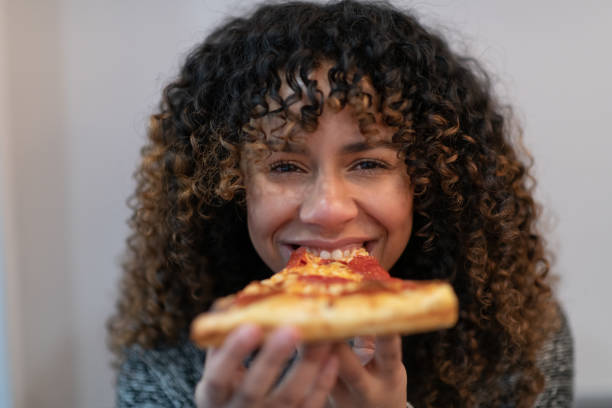 istock Woman eating pizza 1130810276