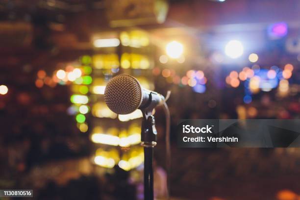 Close Up Microphone On Stage In Concert Hall Restaurant Or Conference Room Blurred Background Stock Photo - Download Image Now