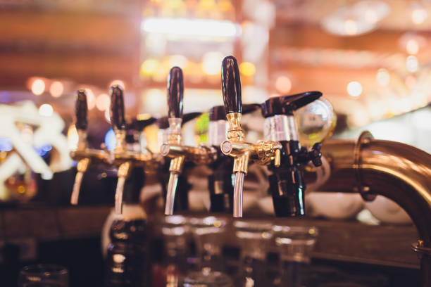 istock beer tap pours draught lager beer serving in a restaurant or pub. 1130810520