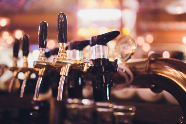 istock beer tap pours draught lager beer serving in a restaurant or pub. 1130810523