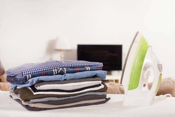istock beautiful woman ironing at home 1130810572