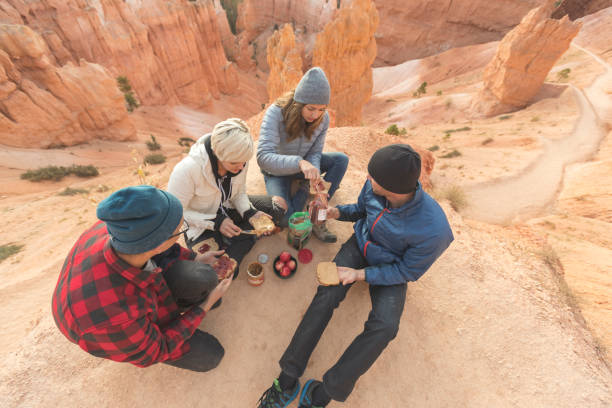 istock Group of hikers eating lunch on a cliff 1130811364