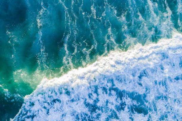 istock Looking down at powerful blue wave in the sea - aerial view 1130812050