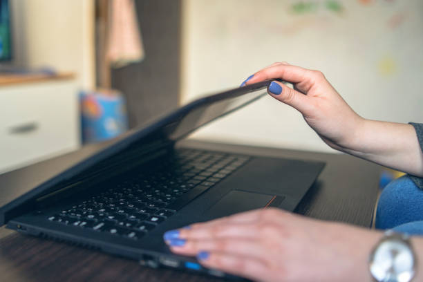 Close up on Female Hands opening the Laptop at Home Close up on Female Hands opening the Laptop at Home closing photos stock pictures, royalty-free photos & images