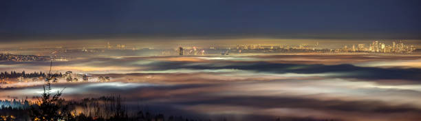 istock Night view of Vancouver emerging from the fog 1130816096