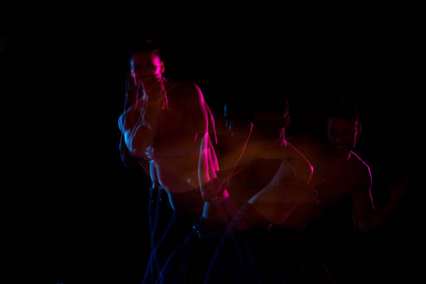 istock Shirtless man dancing with color gel lights 1130817597