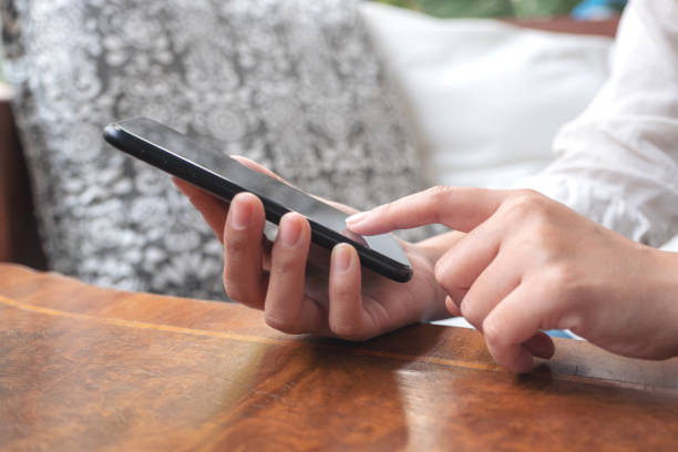 istock A woman's hands holding and pointing a smart phone screen 1130821708