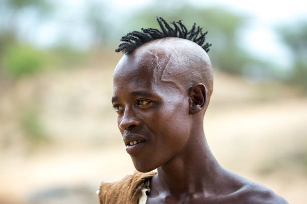 Ethiopia: Bull Jumping Ceremony A handsome young man waits to prove himself in a Bull Jumping Ceremony near Turmi. The Hamer ceremony is a rite of passage for boys turning into men. hamer tribe photos stock pictures, royalty-free photos & images