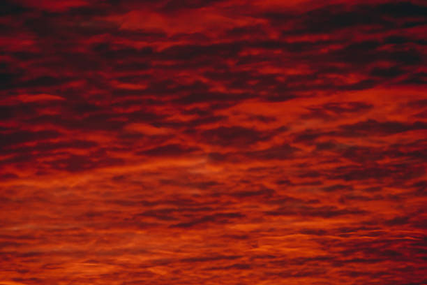 istock Fiery red blood vampire dawn. Amazing warm dramatic fire cloudy sky. Vivid orange sunlight. Atmospheric background of sunrise in overcast weather. Hard cloudiness. Storm clouds warning. Copy space. 1130829341