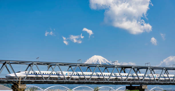 High Speed Bullet Train Shinkansen and Fuji Mountain, Japan Japan - April 15, 2016 : High Speed Train Shinkansen run on the bridge across Fuji river with Fuji Mountian Background, Shizuoka bullet train mount fuji stock pictures, royalty-free photos & images