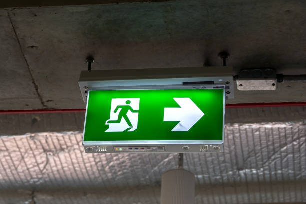 istock Green emergency Fire exit sign showing the way to escape 1130832218