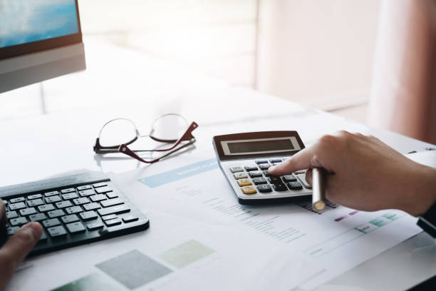 istock Businessman using calculator for calculating finance, tax, accounting, statistics and analytic research concept 1130832813