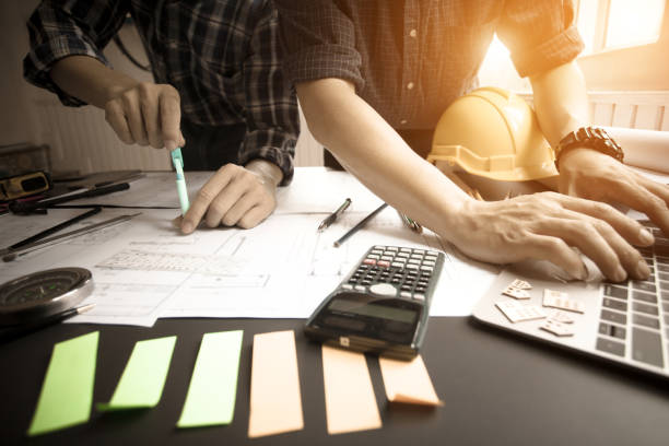 istock Concept Agreement between the employer and architect Nick and desk of Architectural project in construction site or office building 1130834125