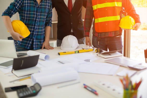 istock Concept Agreement between the employer and architect Nick and desk of Architectural project in construction site or office building 1130834168