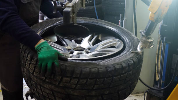 istock Tire service. Work on replacing the wheels in the workshop. 1130834826
